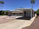Inviting single-story home with awning-covered parking and thoughtfully designed front yard landscaping at 2405 N Eastwood Way, Mesa, AZ 85215