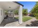 Covered patio with a view of the spacious backyard and lush landscaping, great for outdoor entertaining at 2562 E Los Alamos St, Gilbert, AZ 85295