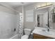 Practical bathroom features a shower/tub combo with a curtain, a sink with a vanity, and storage at 2562 E Los Alamos St, Gilbert, AZ 85295
