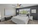 This bright bedroom features a ceiling fan and large windows overlooking a well-manicured yard at 2562 E Los Alamos St, Gilbert, AZ 85295