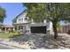 Attractive two-story home with a dark garage door, lush lawn, and mature trees at 2562 E Los Alamos St, Gilbert, AZ 85295