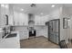 Stylish white kitchen with an island, subway tile backsplash, and wood-look flooring at 2562 E Los Alamos St, Gilbert, AZ 85295