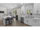 Contemporary kitchen with an island, backyard access, and sleek white cabinetry at 2562 E Los Alamos St, Gilbert, AZ 85295