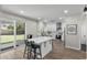 Modern white kitchen featuring an island with seating and stainless steel appliances at 2562 E Los Alamos St, Gilbert, AZ 85295