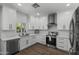 Bright kitchen features modern appliances, white cabinetry, quartz countertops, and stylish tile backsplash at 2562 E Los Alamos St, Gilbert, AZ 85295