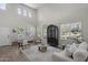 Spacious, naturally lit living room with a soaring ceiling and elegant furnishings at 2562 E Los Alamos St, Gilbert, AZ 85295