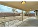 Backyard featuring a covered patio and rock features around the perimeter at 25729 W St Charles Ct, Buckeye, AZ 85326