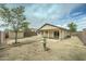 Backyard with a fountain, a covered patio and a storage shed in a yard with xeriscape landscaping at 25729 W St Charles Ct, Buckeye, AZ 85326