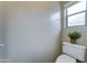 Powder room features toilet, window, and textured walls at 25729 W St Charles Ct, Buckeye, AZ 85326
