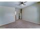 Carpeted bedroom with ceiling fan, closet access, and neutral color palette at 25729 W St Charles Ct, Buckeye, AZ 85326
