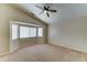 Spacious carpeted bedroom with vaulted ceiling, bay window, and ceiling fan at 25729 W St Charles Ct, Buckeye, AZ 85326