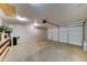 Spacious two car garage with a functional garage door and overhead lighting at 25729 W St Charles Ct, Buckeye, AZ 85326