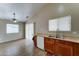 Functional kitchen including a double sink, wooden cabinetry, and a ceiling fan at 25729 W St Charles Ct, Buckeye, AZ 85326