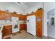 Well-equipped kitchen featuring wooden cabinets, a white appliances, and convenient layout at 25729 W St Charles Ct, Buckeye, AZ 85326