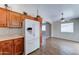 Convenient kitchen setup with a white refrigerator, ample cabinets, and a cozy dining area at 25729 W St Charles Ct, Buckeye, AZ 85326