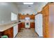 Bright kitchen featuring ample wooden cabinetry, white appliances, and durable countertops at 25729 W St Charles Ct, Buckeye, AZ 85326