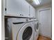 Functional laundry room with front load washer/dryer and storage cabinets at 25729 W St Charles Ct, Buckeye, AZ 85326