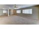 Expansive living room featuring plush carpeting, abundant natural light, and neutral color palette at 25729 W St Charles Ct, Buckeye, AZ 85326