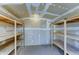 Interior of a storage shed with wood shelving along the walls at 25729 W St Charles Ct, Buckeye, AZ 85326