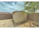Exterior view of a storage shed surrounded by a block wall and xeriscape landscaping at 25729 W St Charles Ct, Buckeye, AZ 85326