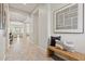 Inviting hallway with tiled floors leads to a bright living area; note the stylish woven bench with decorative pillows at 2604 W Balao Dr, Phoenix, AZ 85085