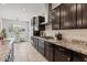 Stylish kitchen with dark cabinets, granite countertops, stainless steel appliances and tile backsplash provides ample space at 2604 W Balao Dr, Phoenix, AZ 85085