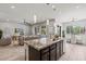 Open-concept kitchen featuring a center island that overlooks the living room and dining area at 2604 W Balao Dr, Phoenix, AZ 85085
