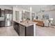 Spacious kitchen island with granite countertop, bar seating, and stainless steel appliances offers a modern design at 2604 W Balao Dr, Phoenix, AZ 85085