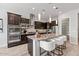Modern kitchen with stainless steel appliances, granite countertops, and a large center island at 2604 W Balao Dr, Phoenix, AZ 85085