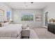 Bright bedroom with a neutral color scheme, large window, and private access to the backyard at 2604 W Balao Dr, Phoenix, AZ 85085