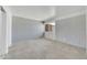 Bright bedroom with a large window, carpet, and light gray brick accent wall at 27250 N 64Th St # 16, Scottsdale, AZ 85266