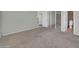 Spacious bedroom with carpet, closet with sliding mirror doors, and a bathroom on the side at 27250 N 64Th St # 16, Scottsdale, AZ 85266