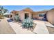 Single story home with desert landscaping, paved walkway, and brick exterior at 27250 N 64Th St # 16, Scottsdale, AZ 85266