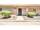 Charming front entrance with well-maintained landscaping and a secure black security door at 27250 N 64Th St # 16, Scottsdale, AZ 85266