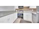 Bright kitchen features white cabinets, stainless steel appliances, gray countertops, and brick backsplash at 27250 N 64Th St # 16, Scottsdale, AZ 85266