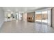 Spacious living room with tile flooring, brick walls, and a sliding glass door to the outside at 27250 N 64Th St # 16, Scottsdale, AZ 85266