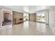 Bright living room with large windows, brick accent wall, and neutral tile flooring at 27250 N 64Th St # 16, Scottsdale, AZ 85266
