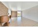 Open living area with tile flooring, brick wall and a view to a backyard at 27250 N 64Th St # 16, Scottsdale, AZ 85266