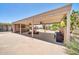 Community patio with seating, ceiling fans, cacti, desert landscaping, and bikes at 27250 N 64Th St # 16, Scottsdale, AZ 85266