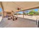 Community patio with desert landscaping, ceiling fans, and picnic seating at 27250 N 64Th St # 16, Scottsdale, AZ 85266