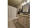Tiled bathroom featuring granite counters, decorative lighting, and shower with curtain at 2919 E Friess E Dr, Phoenix, AZ 85032