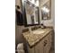Bathroom featuring granite counters, modern lighting, and framed mirrors at 2919 E Friess E Dr, Phoenix, AZ 85032