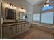 This bathroom boasts a double sink vanity with granite countertops, a corner tub, and tiled floors at 2919 E Friess E Dr, Phoenix, AZ 85032