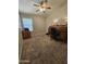 Carpeted bedroom featuring a ceiling fan and wood desk at 2919 E Friess E Dr, Phoenix, AZ 85032