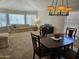 Inviting dining area adjacent to a living space, featuring a wooden table and ample natural light at 2919 E Friess E Dr, Phoenix, AZ 85032