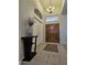 Welcoming foyer with tiled floors, a decorative table, and a view of the beautiful wood double doors at 2919 E Friess E Dr, Phoenix, AZ 85032
