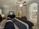 Large bedroom with a ceiling fan, adjoining bathroom with double sinks, and a walk-in closet at 2919 E Friess E Dr, Phoenix, AZ 85032