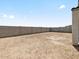 Large, undeveloped backyard space enclosed by a block wall, offering a blank canvas for landscaping and outdoor enjoyment at 4035 S 176Th Dr, Goodyear, AZ 85338