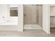 Bathroom with glass enclosed shower with tiled surround, and separate tub at 4035 S 176Th Dr, Goodyear, AZ 85338