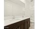 A bathroom featuring double sinks, a large mirror, and dark wood cabinets at 4035 S 176Th Dr, Goodyear, AZ 85338
